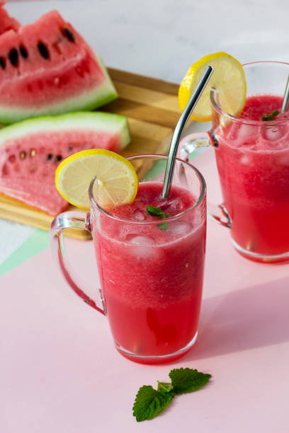 istock A glass of watermelon smoothie with ice, mint and lemon. Selective focus. 1273251475