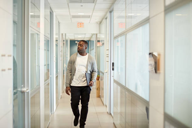 istock Casual Black Freelancer in Mid 20s Walking in Miami Office 1273251546