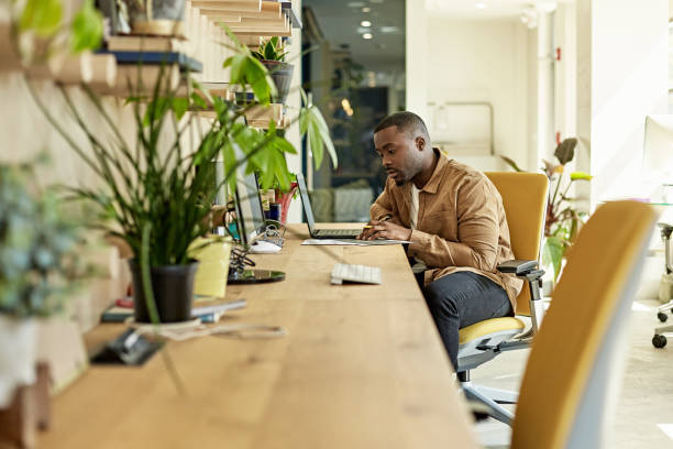 istock Casual Black Professional Working on Laptop in Miami Office 1273251569