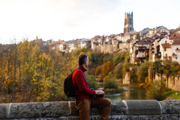 istock Traveler with backpack taking photo by mobile phone. back 1273253403