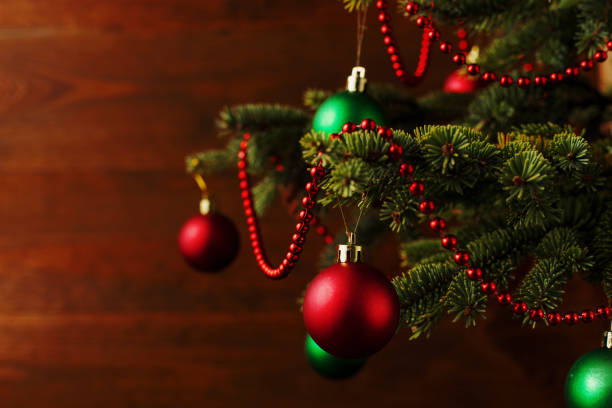 istock Christmas tree, dressed up balls, stands on a wooden table. Copy space. 1273253642