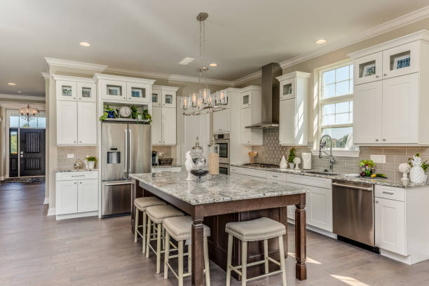 Gorgeous kitchen with ample seating for dining around the island White cabinets with quartz countertops kitchen island stock pictures, royalty-free photos & images