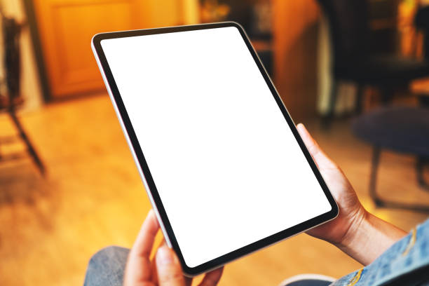 istock a woman holding digital tablet with blank white desktop screen 1273255520