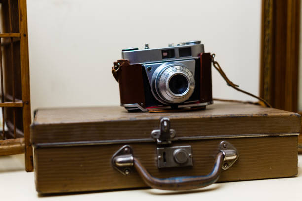 istock Vintage photo camera on background 1273257215