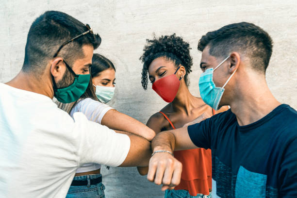 istock Young people from different races greet each other with the elbow. New normality coronavirus (covid-19) concept. 1273258103