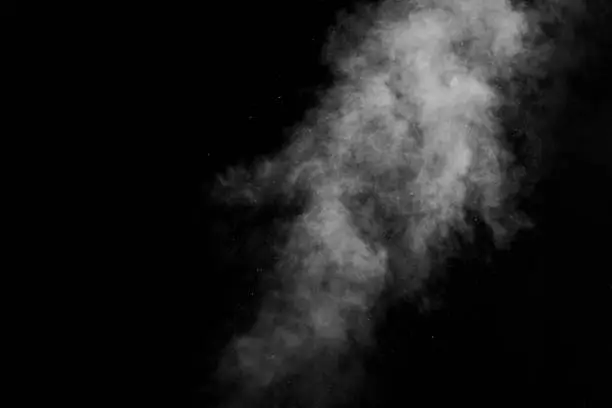 Photo of Figured smoke on a dark background. Abstract background, design element, for overlay on pictures