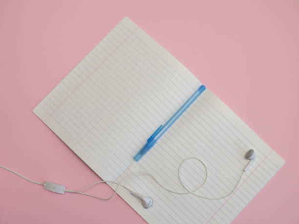 notebook in a line with a pen for writing and headphones on a pink background Workspace of freelancer, blogger, journalist - laptop, notepad, pen, cup of trendy superfood pink beetroot latte, porcelain pitcher, headphones on pastel pink background, flat lay, copy space common beet audio stock pictures, royalty-free photos & images