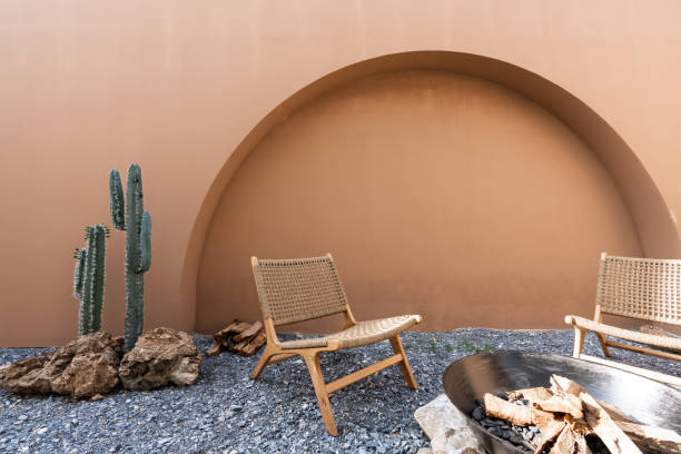istock Minimal empty space scene with brown painted wall and  rattan armchair and artificial cactus with rock setting  in natural light scene / studio concept / tropical theme / outdoor studio / modern minimal style 1273265962