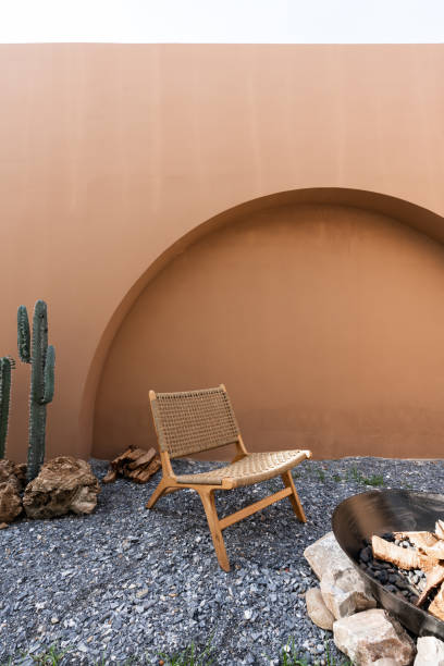 istock Minimal empty space scene with brown painted wall and  rattan armchair and artificial cactus with rock setting  in natural light scene / studio concept / tropical theme / outdoor studio / modern minimal style 1273265965