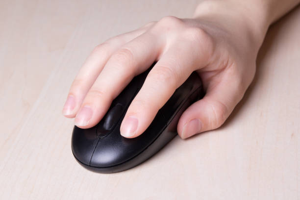 istock mouse in female hand on wooden table 1273268111