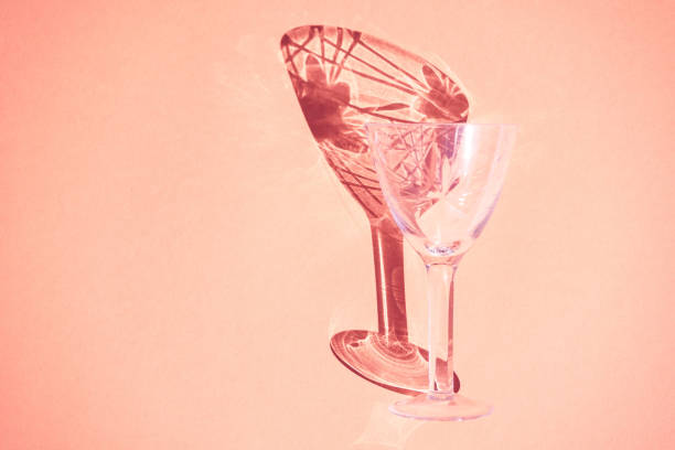 istock Beautiful abstract background wine glass light rays refracting, coral pastel color background, abstract design bright fun flat lay, light through glass shadow on colorful backdrop. 1273268117