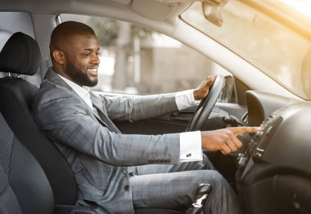 istock African man driver turning on music in car before moving 1273272344