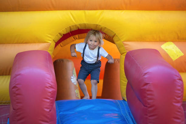 istock Children, boys, playing jumping on colorful trampoline 1273274184