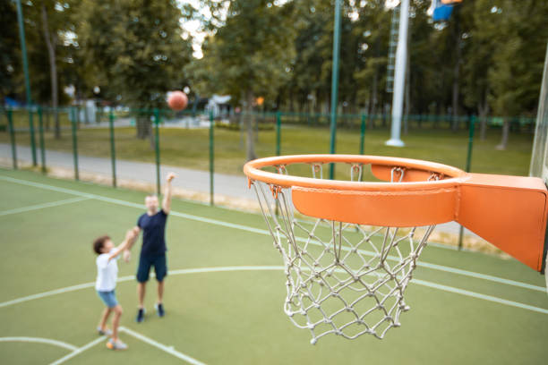 istock Man throwing ball, playing basketball with his son 1273274215