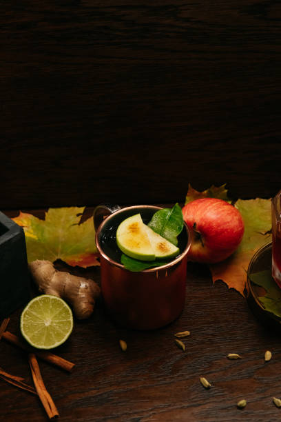 istock Autumn fruit alcoholic cocktails with apple, lime, orange and cinnamon on the table in restaurant 1273274936