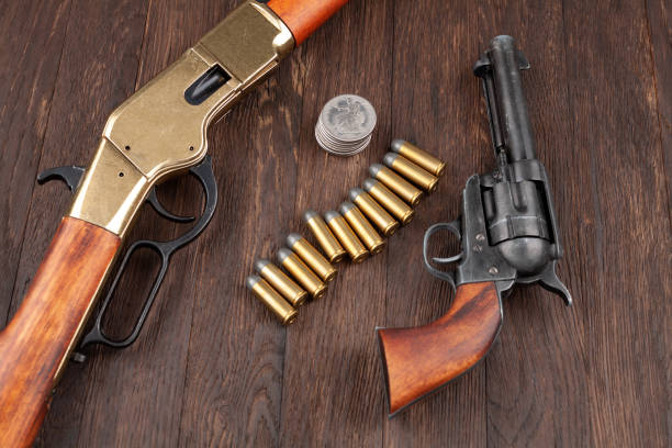 istock Wild west guns and ammunition with silver dollars 1273276122