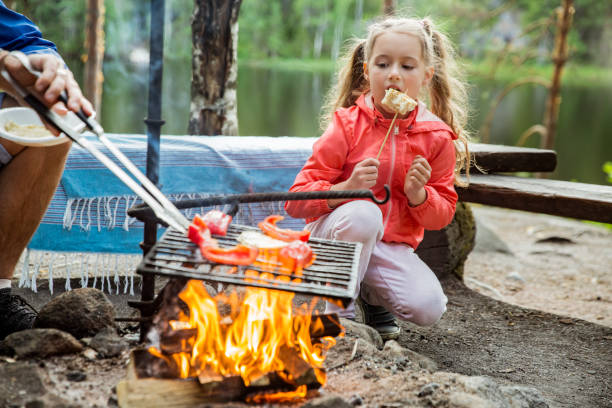 istock Man and his little daughter having barbecue in forest 1273276428