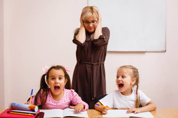 istock Two naughty schoolgirls in school class 1273277129