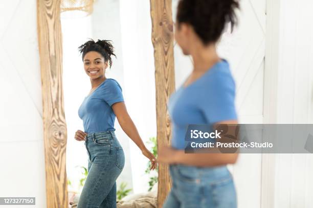 Joyful African American Girl After Slimming Looking In Mirror Indoor Stock Photo - Download Image Now