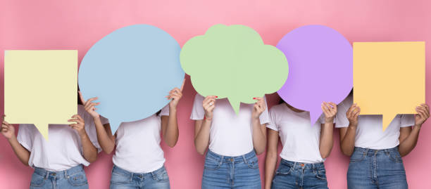 Unrecognizabe Ladies Holding Empty Colorful Speech Bubbles Standing In Studio