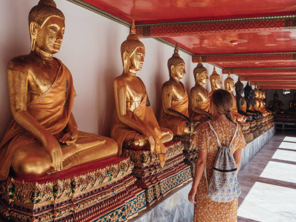 istock Woman visits temple with buddhas in Thailand 1273277797
