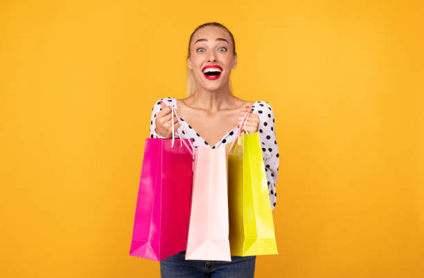 istock Overjoyed woman showing shopping bags at studio 1273277930