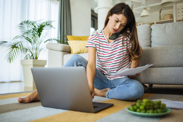 istock Mid adult woman working from home using laptop 1273278963