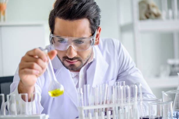 istock Attractive happiness scientist man lab technician assistant analyzing sample in test tube at laboratory. Medical, pharmaceutical and scientific research and development concept. 1273279137
