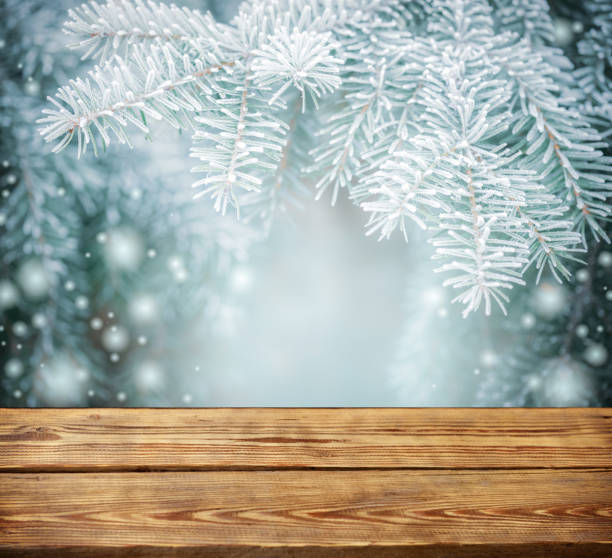 istock Christmas tree branches with wooden background 1273279226
