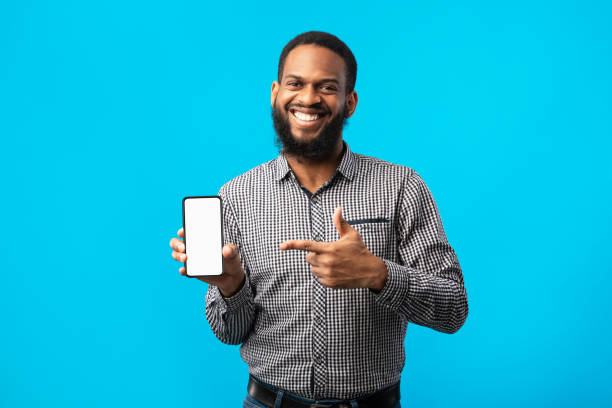 istock Afro man showing blank cell phone screen 1273281828