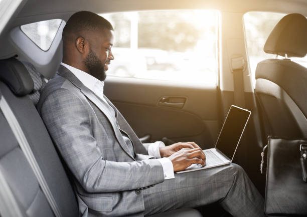 istock Black guy businessman working on laptop with blank screen 1273281833