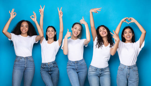 istock Five Positive Young Women Gesturing Different Signs Over Blue Background 1273281857