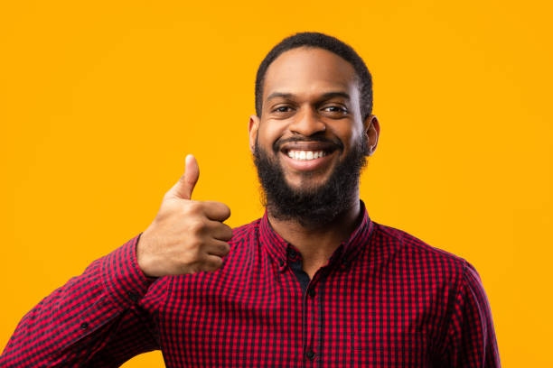 istock Happy black man gesturing thumbs up and smiling 1273282274