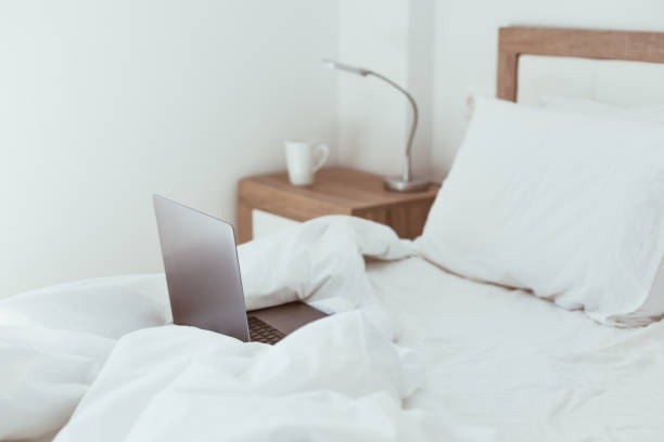 istock Working home isolation concept. Laptop in bed 1273283850