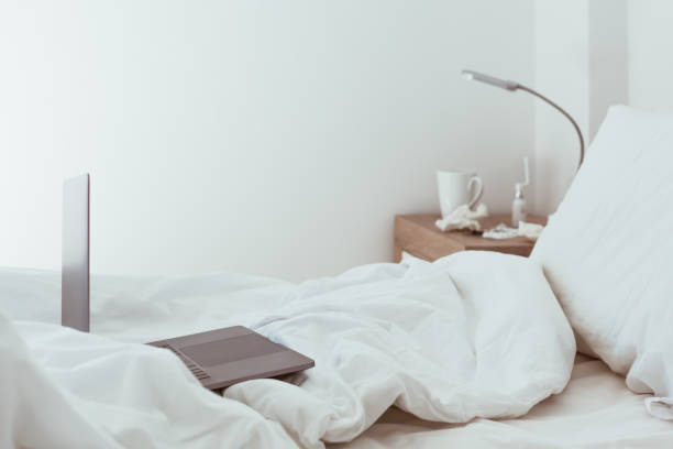 istock Working home isolation concept. Laptop in bed 1273283869