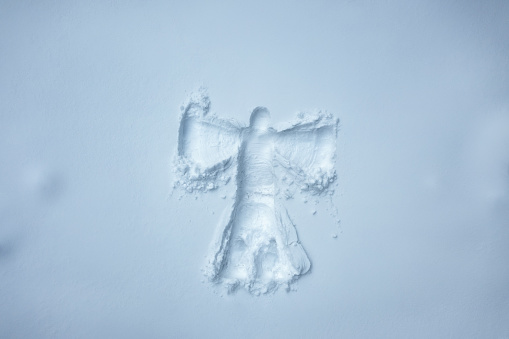 Snow angel in fresh snow. Aerial view.