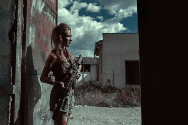 Female warrior during wartime Blond female warrior during wartime looking away protecting building female sharp shooter stock pictures, royalty-free photos & images