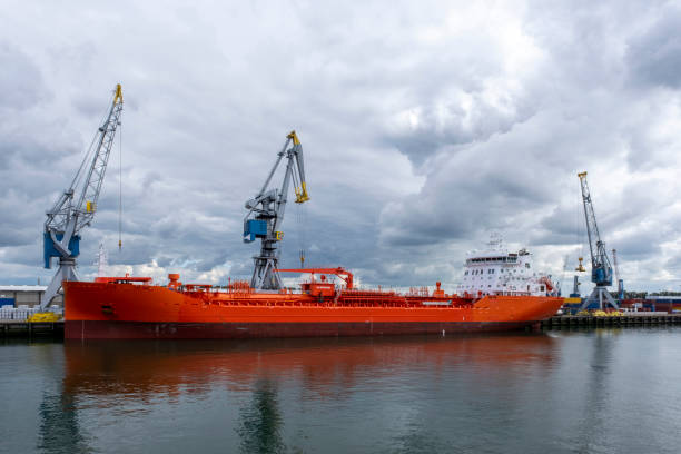 istock Logistics and transportation of Container Cargo ship and Cargo plane with working crane bridge in shipyard 1273285293