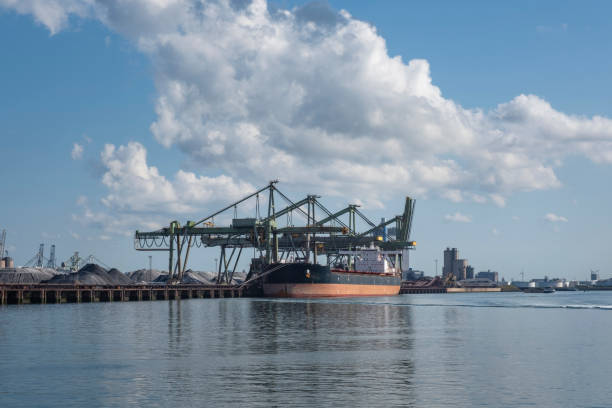 istock Logistics and transportation of Container Cargo ship and Cargo plane with working crane bridge in shipyard 1273285296