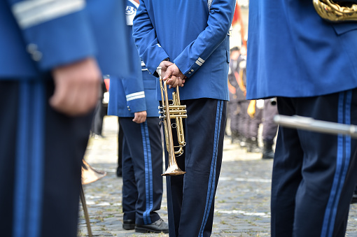 Part of a brass band with a human hand on the Tuba.