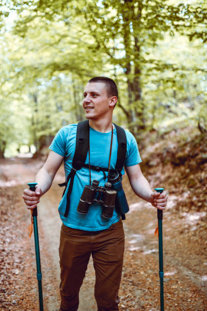 istock Young Hiker Smiling And Enjoying Forest View During Hiking 1273286224