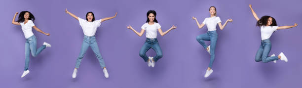istock Five Multiracial Women Jumping Posing In Mid-Air Over Purple Background 1273286565