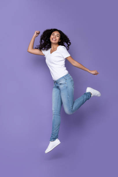 istock Happy Mexican Lady Jumping Posing In Studio, Vertical Shot 1273286846