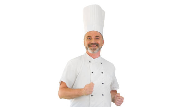 istock Mature chef with beard and in white uniform dancing on white bac 1273286939