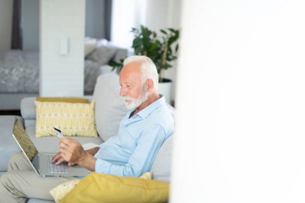 istock Senior man buying online from home 1273289387