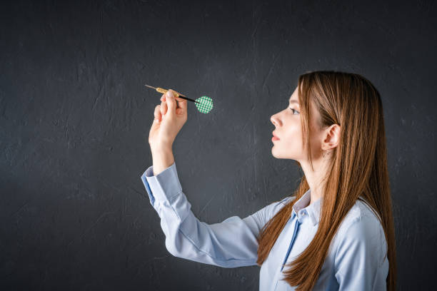 Confident businesswoman throwing dart Dart, Darts, Throwing, Activity, Adult woman darts stock pictures, royalty-free photos & images