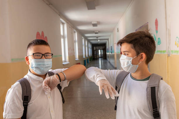 istock Two boys respecting social distance in school 1273291049