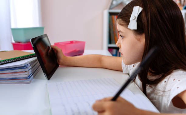 istock Girl doing homework with the tablet 1273291231