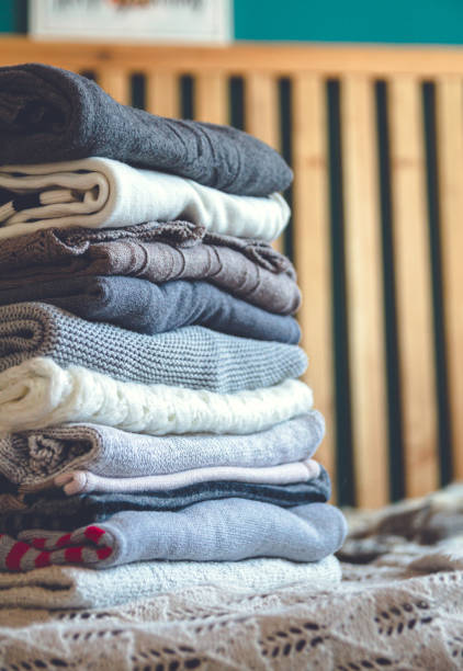 istock A stack of cozy warm winter clothes lies on the bed 1273292101