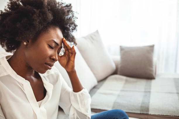 istock Young woman with headache in home interior. 1273292462